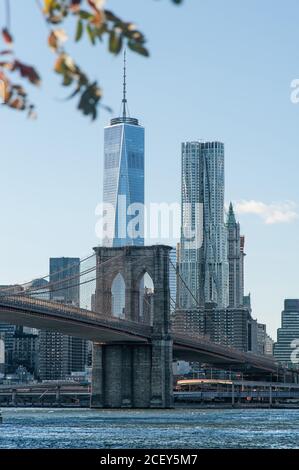 Amazing view of stone Brooklyn bridge crossing river on background of skyscrapers in New York Stock Photo