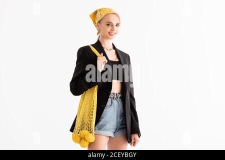 fashionable woman posing with lemons in string bag isolated on white Stock Photo