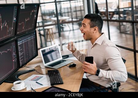 Businessman rejoiced, analyzing index on cryptocurrency diagram Stock Photo