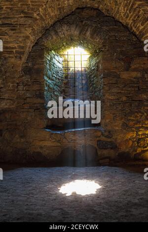 Rays of light shining into the medieval cellar Stock Photo