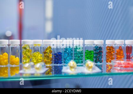 Colorful medical capsules, pills, vitamins, tablets, drugs, meds in clear plastic bottle for sale at pharmacy drug store, pharmaceutical exhibition Stock Photo