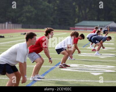 High school students exercising on a football field Stock Photo