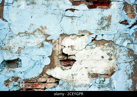 Old blue red brick wall. Abstract background and texture of cracked bricks and blue painted wall. Stock Photo
