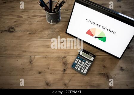 online finances hand pressing credit score button on tablet Stock Photo