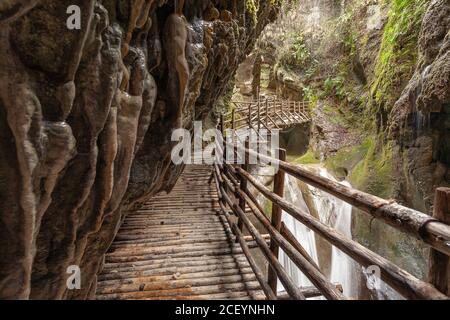 Stalactites above the walkway in caves carved out of sandstone Stock Photo