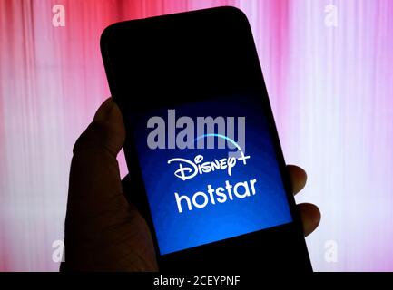 In this photo illustration a Disney Hotstar company Logo seen displayed on a smartphone. Stock Photo