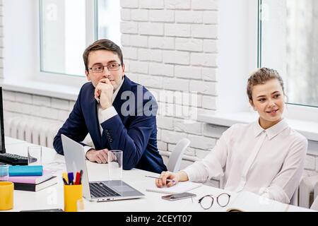 friendly and beautiful caucasian business people gathered to discuss, to have useful communication about new project based on finance, successful corp Stock Photo
