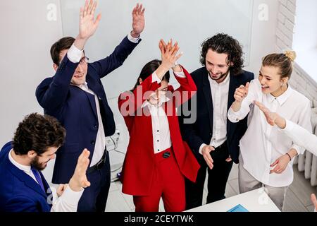 successful business people together in office, happy ladies and guys enjoy working on joint project, taking best results every day Stock Photo