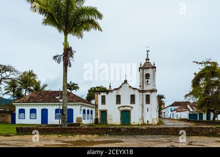 Front facade of colonial house and church in historical brazilian town Stock Photo