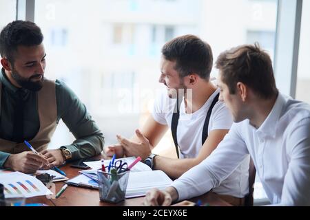 international group of people, business team gathered on table to discuss business ideas, using papers, diagrams. Creative business people Stock Photo