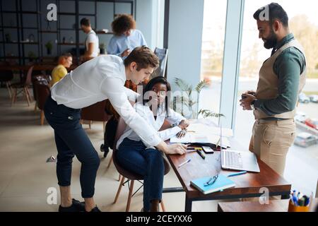 busy multi-ethnic business people working together in coworking space, diverse employees staff, business team talking together in office, project team Stock Photo