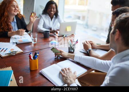 international group of people, business team gathered on table to discuss business ideas, using papers, diagrams. Creative business people Stock Photo