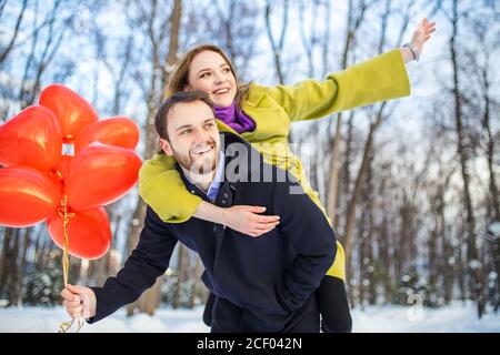 cheerful, joyfu, happy caucasian couple spend time together, man and woman in love, celebrate st valentines day in winter street, after romantic date Stock Photo
