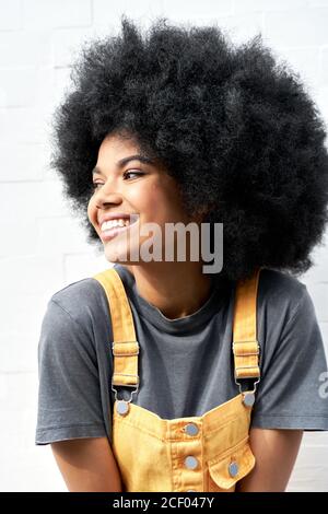 Smiling African lady with Afro hair laughing standing on white background. Stock Photo