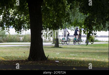 Toronto, Canada. 2nd Sep, 2020. People ride shared bikes in a park in Toronto, Canada, on Sept. 2, 2020. Starting Sept. 2, riders of Bike Share Toronto will be offered free trips in the city on Wednesdays in September. Credit: Zou Zheng/Xinhua/Alamy Live News Stock Photo