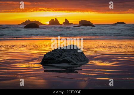 Fire red sunset over sea stacks at Oregon Coast.  Stock Photo