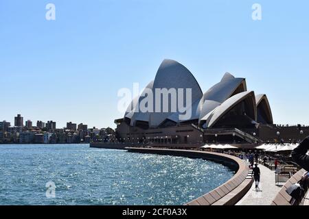 Looking towards the Sydney Opera House from Circular Quay.  The Opera Bar & Kitchen can be seen along the waterfront.  New South Wales, Australia. Stock Photo