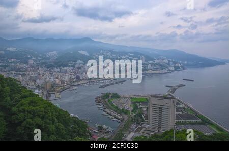 An aerial view of Atami, a coastal resort town a few hours from Tokyo, Japan, on an overcast afternoon in summer