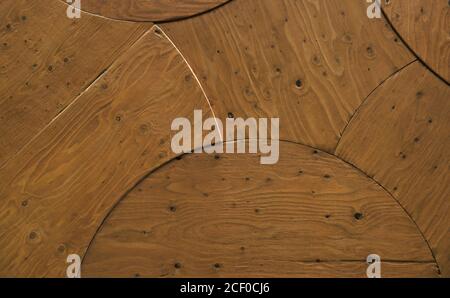 Textured surface of wooden boards cut and fit together in a curved geometric pattern Stock Photo