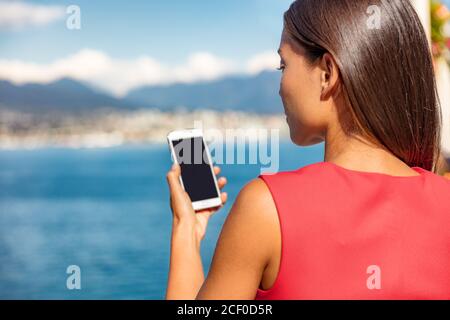 Businesswoman holding phone looking at screen Stock Photo