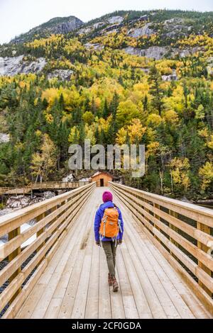 Hike woman walking in forest nature outdoor bridge Stock Photo