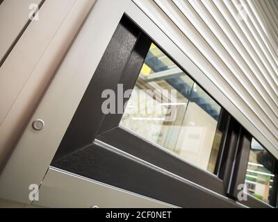 Fragment of a window protected by roller shutters Stock Photo