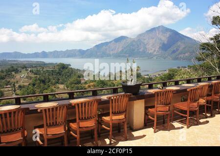 Batur Lake view from balcony with row of wooden chairs in Bali, Indonesia Stock Photo