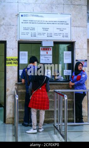 Jakarta, Indonesia - July 24, 2019: Visitors buy tickets to the top yard of the national monument (monas). Stock Photo