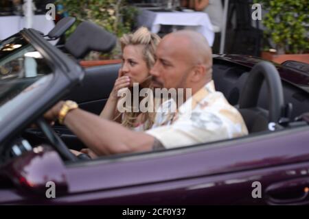 MIAMI BEACH, FL - APRIL 25: (EXCLUSIVE COVERAGE) Israli super-model Bar Paly and Dwayne 'The Rock' Johnson film a scene together in a purple Chrysler Prowler, on the set of Pain and Gain which is directed by Michael Bay. Pain and Gain is about a pair of bodybuilders in Florida get caught up in an extortion ring and a kidnapping scheme that goes terribly wrong. on April 25, 2012 in Miami Beach, Florida. ( Credit: Storms Media Group/Alamy Live News Stock Photo