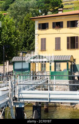 Domaso. Lake Como. Italy - July 21, 2019: Ferry Pier in the Commune of Domaso. Lombardy. Signboard with Name of the City.