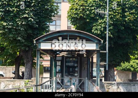 Dongo. Lake Como. Italy - July 21, 2019: Ferry Pier in the Commune of Dongo. Lombardy. Signboard with Name of the City.
