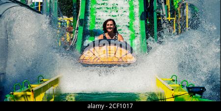Woman on roller coaster in amusement theme park Stock Photo