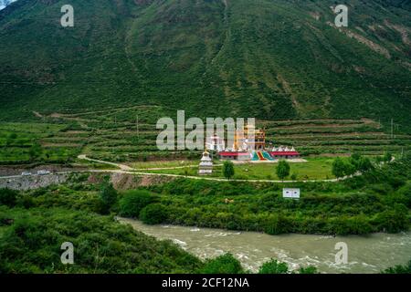 A tibetan village in the valley of mountains, in summer time. Stock Photo