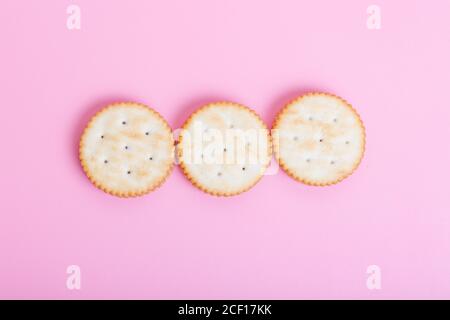 Cream sandwich biscuits on pink background Stock Photo