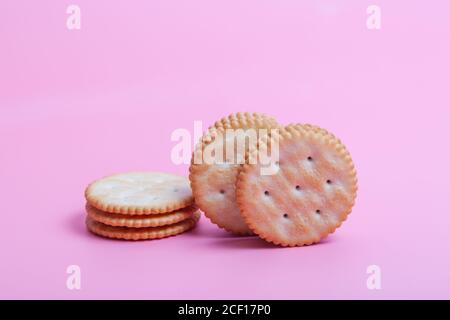 Cream sandwich biscuits on pink background Stock Photo