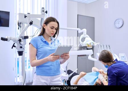 Portrait of dentist doctor with digital tablet Stock Photo