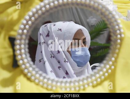 Beijing, China. 6th Aug, 2020. Photo taken on Aug. 6, 2020 shows the reflection of an Afghan bride in a mirror during a collective wedding party in Mazar-i-Sharif, capital of the northern Balkh province, Afghanistan. Credit: Kawa Basharat/Xinhua/Alamy Live News Stock Photo