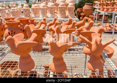 Group of orange birds of clay  outside at pottery shop Stock Photo