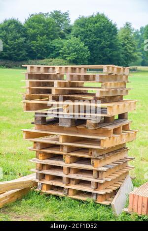High stack of wooden pallets in dutch pasture Stock Photo