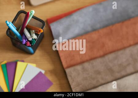 Close-up of colored markers and fabric samples on the workplace of designer Stock Photo