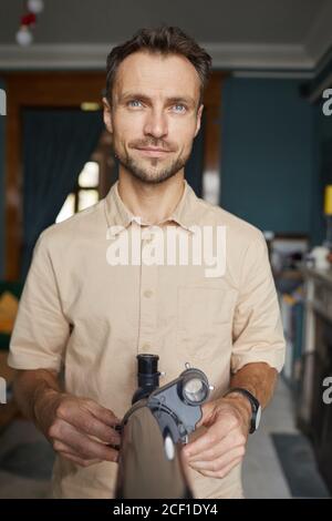 Portrait of young astronomer looking at camera while using his telescope to watch for the stars Stock Photo