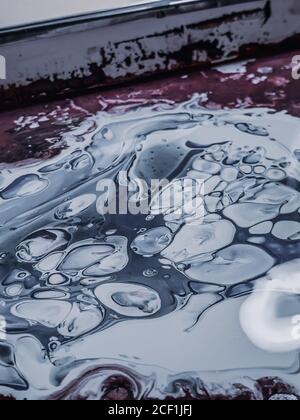 Vertical shot of an abstract oily painting with mixed colors on a canvas Stock Photo