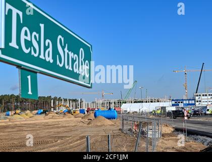 03 September 2020, Brandenburg, Grünheide: A road sign 'Tesla Straße 1' is located at the entrance to the Tesla Gigafactory construction site. In Grünheide near Berlin, a maximum of 500,000 vehicles per year are to roll off the assembly line from July 2021 onwards - and according to the plans of the car manufacturer, the maximum is to be reached as quickly as possible. For the time being, the US electric car manufacturer expects up to 10,500 employees in shift operation for its planned first factory in Europe. Photo: Patrick Pleul/dpa-Zentralbild/dpa Stock Photo