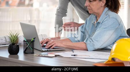 Architects working on new construction project and using laptop Stock Photo