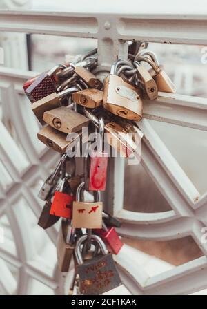 Vertical shot of a bunch of padlocks on a chain around a fence Stock Photo