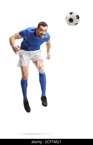 Full length portrait of a footballer jumping and hitting a ball with head isolated on white background Stock Photo