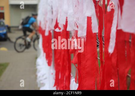 Belarus national flag made of ribbons on fence. Symbol of hope and freedom. Peaceful protest after president elections 2020. Stock Photo