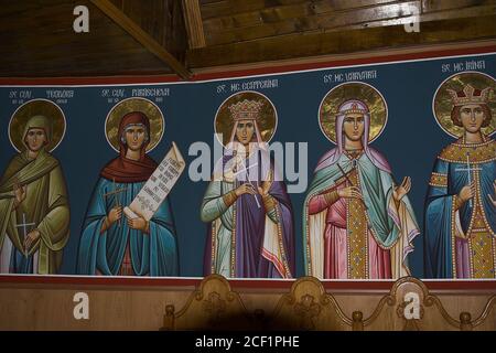 Romania, the interior of a wooden Orthodox church, contemporary icons of holy women. Das Innere einer orthodoxen Holzkirche, Ikonen heiliger Frauen. Stock Photo