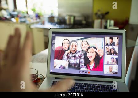 POV Friends video chatting on laptop screen Stock Photo