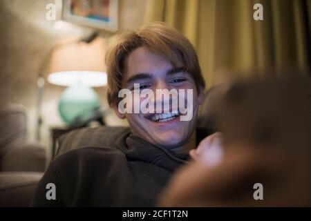 Close up smiling teenage boy using smart phone Stock Photo